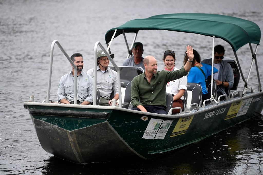 Prince William waves from a boat as he leaves after a meeting with Paqueta Island residents in Rio de Janeiro, Brazil