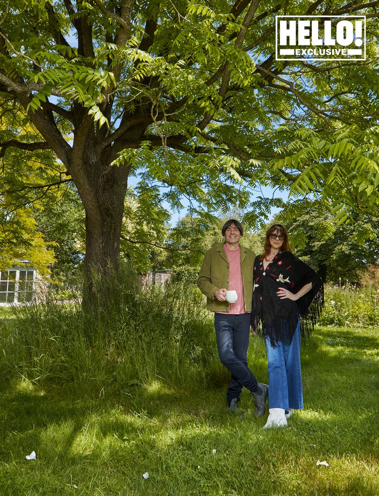 Blur star Alex James and wife Claire posing in grounds of farmhouse in Kingham, Oxfordshire 