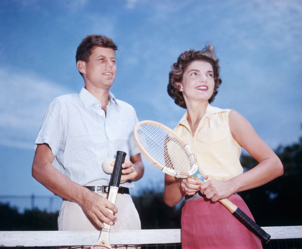 Senator John Kennedy and his fiancee Jacqueline Bouvier play tennis.