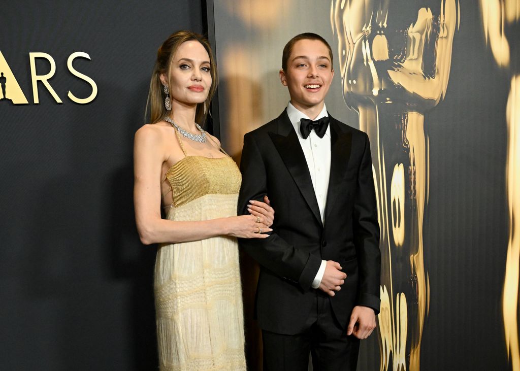 Angelina Jolie and towering son Knox steal the show with ultra-rare red ...