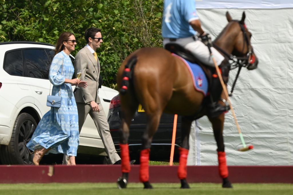 Princess Kate was seen holding champagne, polo