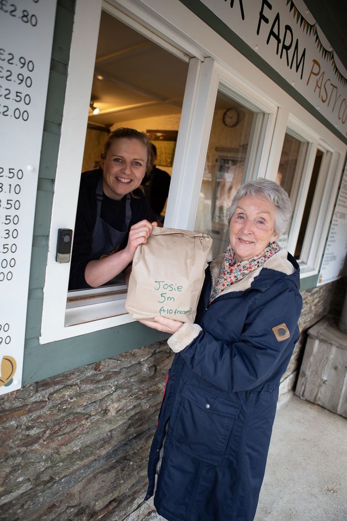 A photo of a woman holding a brown bag