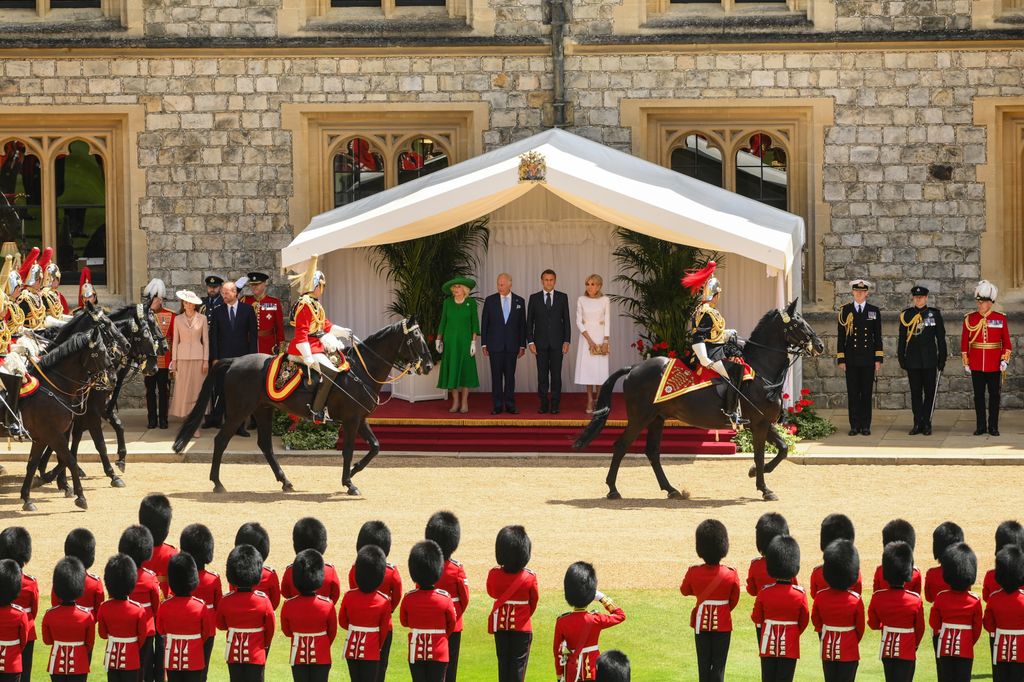King Charles III, Queen Camilla, President of France, Emmanuel Macron and Brigitte Macron review military in bear skins