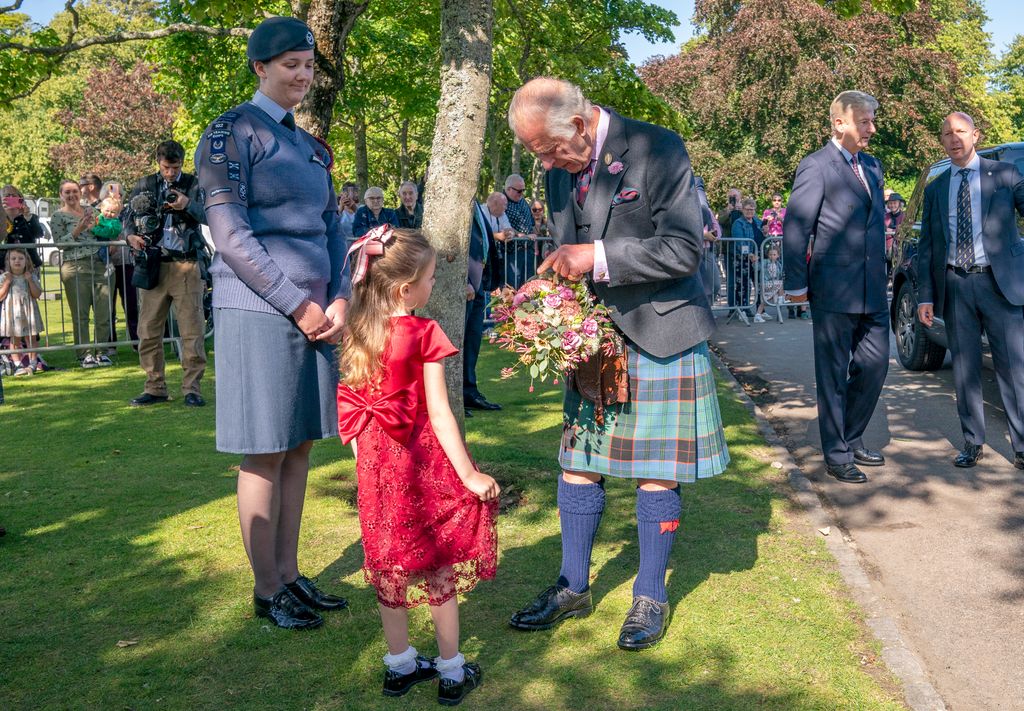 King Charles receiving flowers from Charlotte Keith, 5, from Portlethen