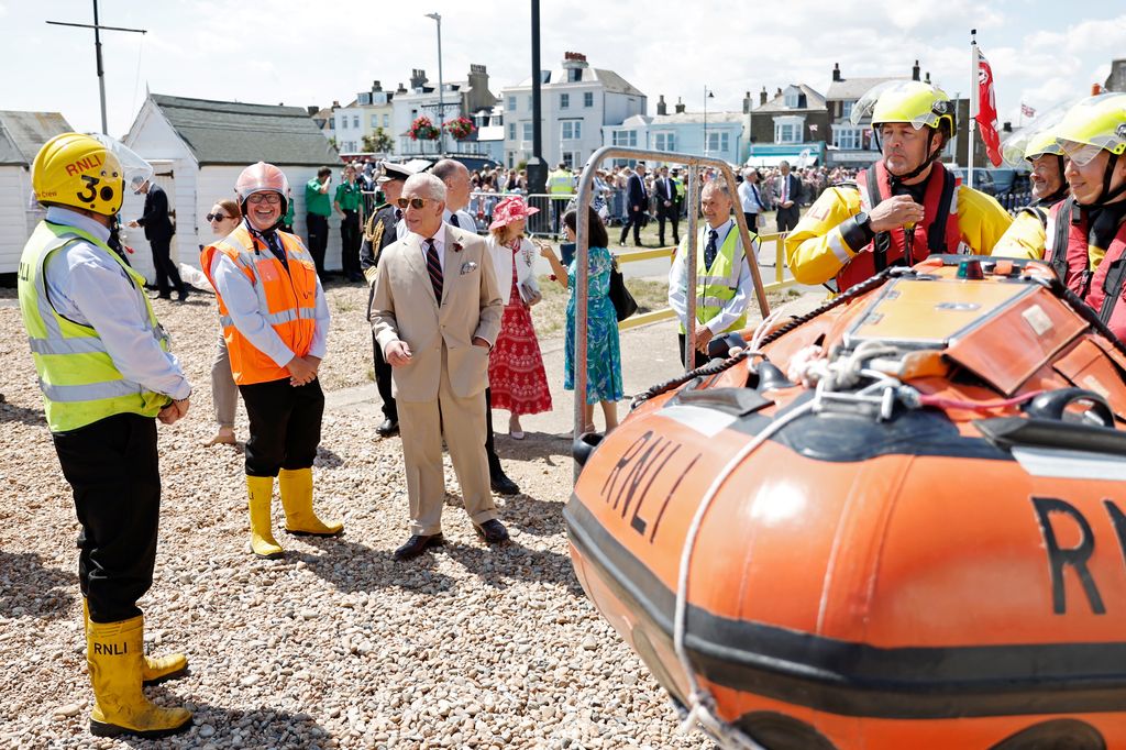 King Charles on beach with R.N.L.I. Lifeboat workers