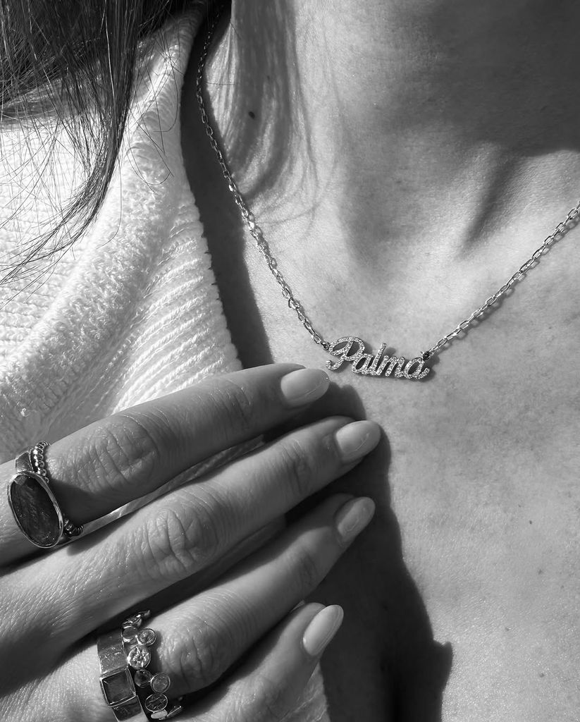 Black and white image of Michelle Keegan's nameplate 'Palma' necklace