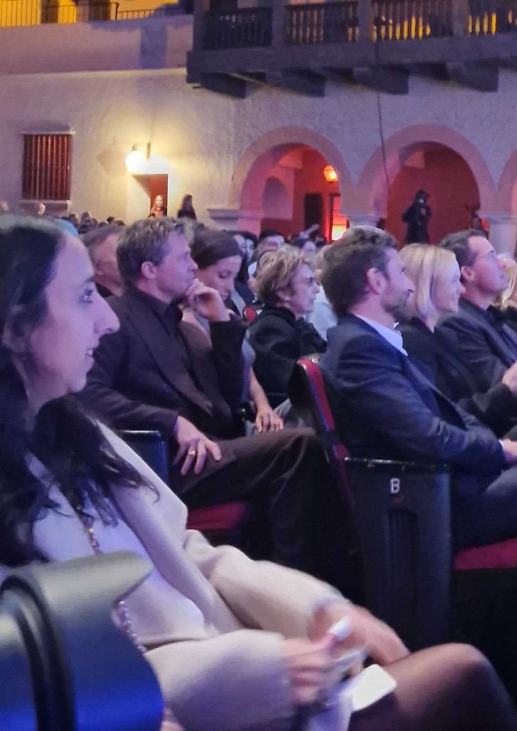 Brad Pitt and Ines de Ramon sit behind Bradley Cooper and Carey Mulligan