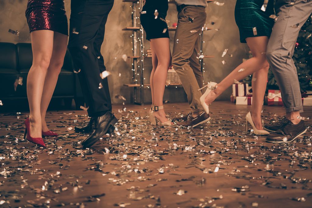 People dancing in heels with confetti at christmas