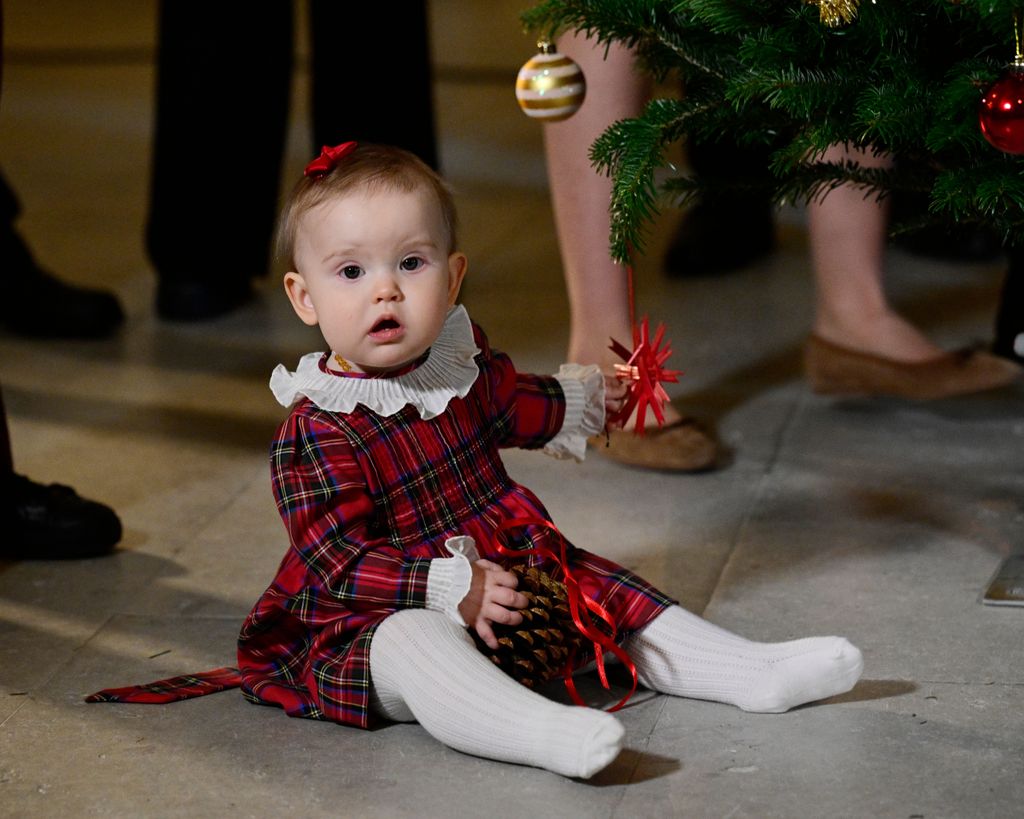 Princess Ines on floor in a tartan dress