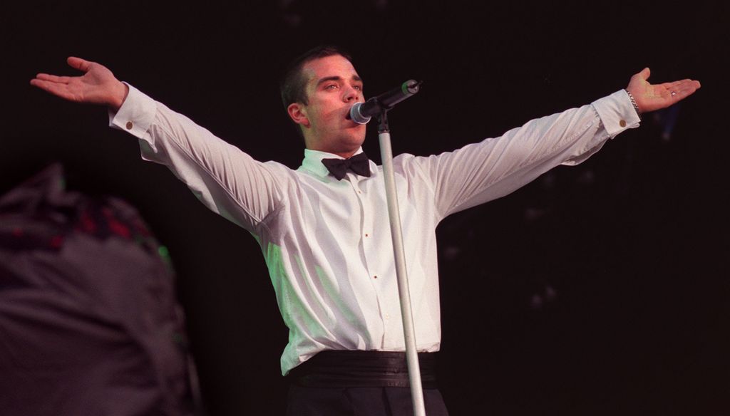 Singer Robbie Williams performs one of his hits at the V98 Chelmsford festival
