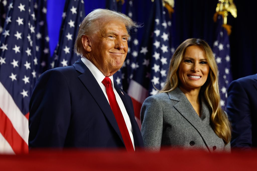 Republican presidential nominee, former U.S. President Donald Trump and former first lady Melania Trump look on during an election night event at the Palm Beach Convention Center on November 06, 2024 in West Palm Beach, Florida. Americans cast their ballots today in the presidential race between Republican nominee former President Donald Trump and Vice President Kamala Harris, as well as multiple state elections that will determine the balance of power in Congress