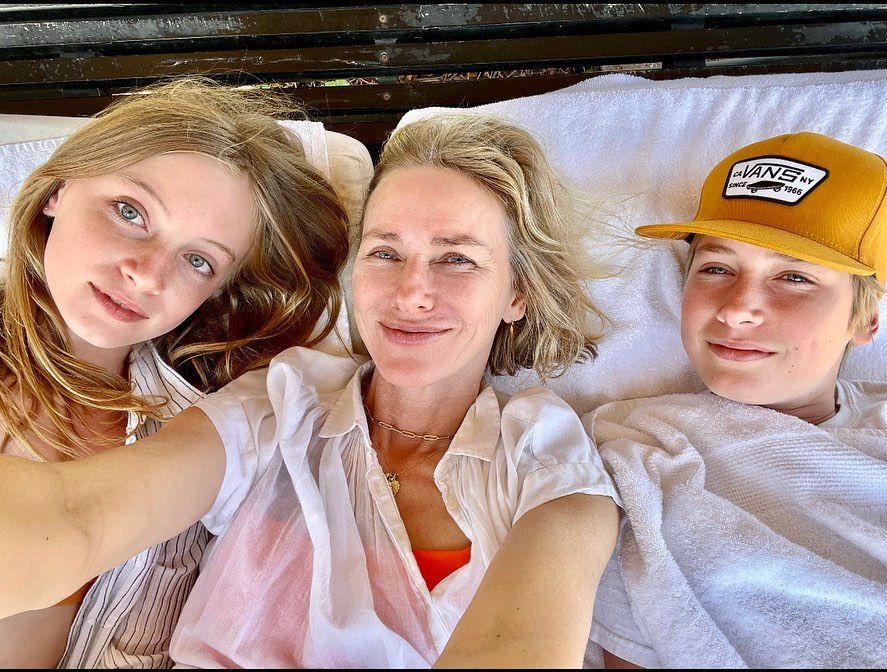 Kai, Naomi Watts and Sasha take a selfie while lying on a sofa