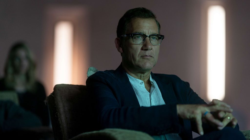 man in glasses sitting in chair