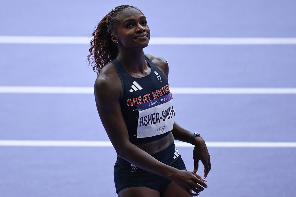 Britain's Dina Asher-Smith reacts after competing in the women's 100m heat of the athletics event at the Paris 2024 Olympic Games at Stade de France in Saint-Denis, north of Paris, on August 2, 2024