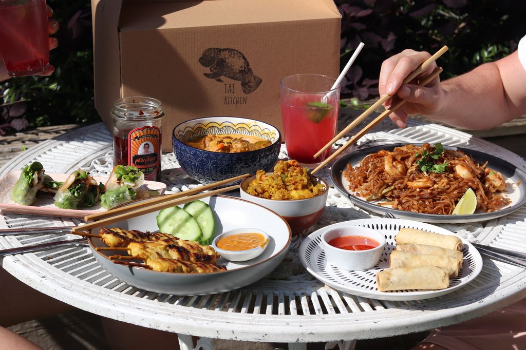 Tai food laid out with a cocktail