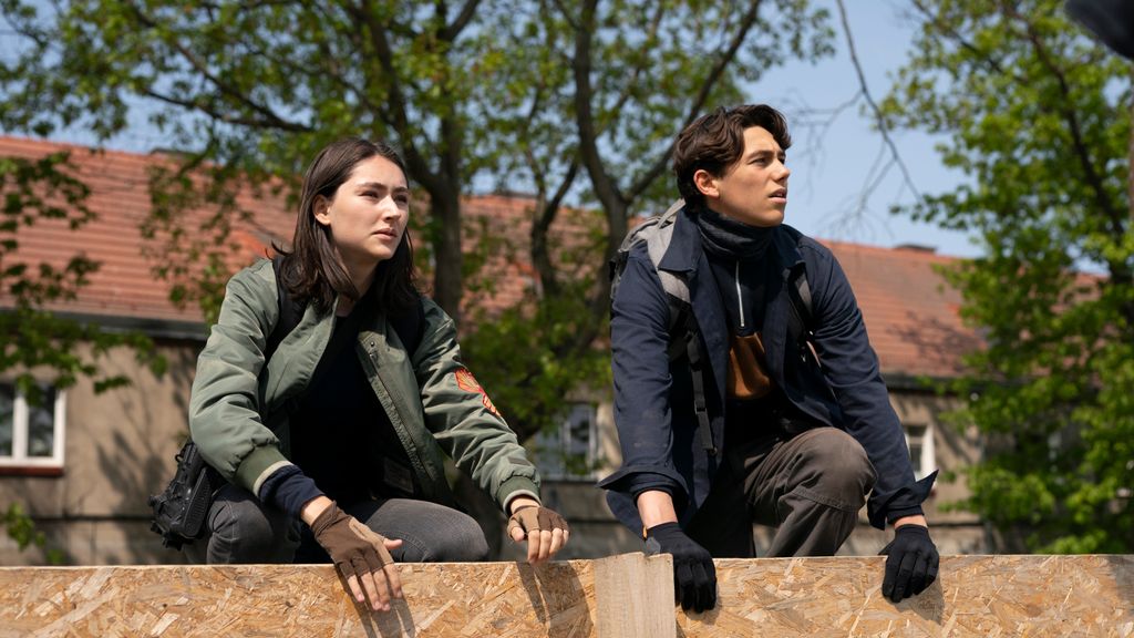 young woman and man on wall