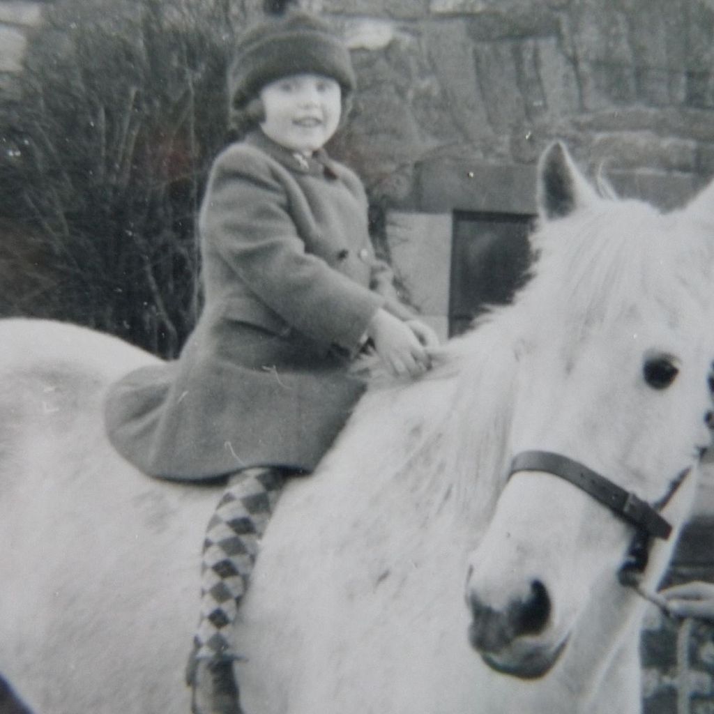 Sarah Ferguson wearing harlequin tights on a horse as a young chold