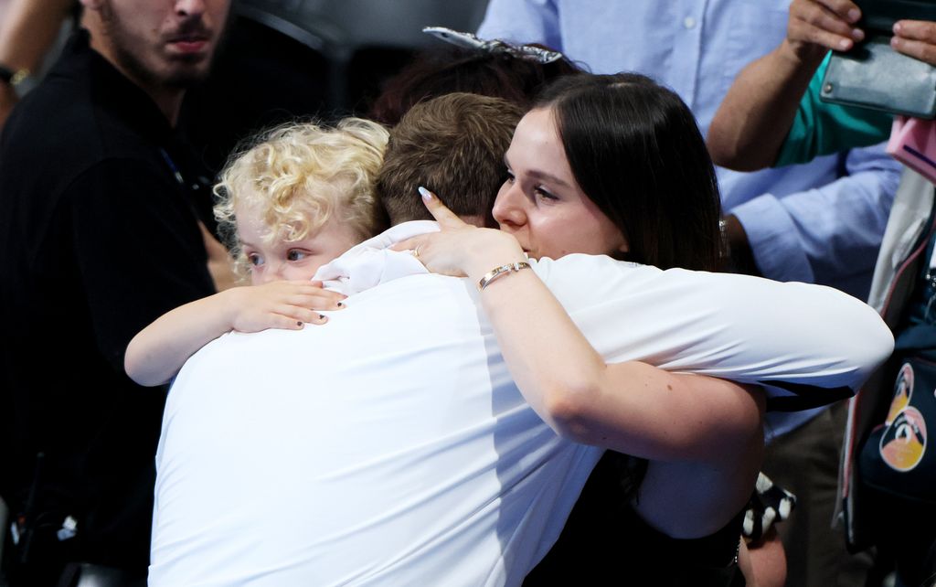 three people sharing hug 