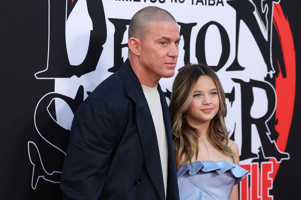 Channing Tatum in navy suit and Everly Tatum in blue dress on red carpet