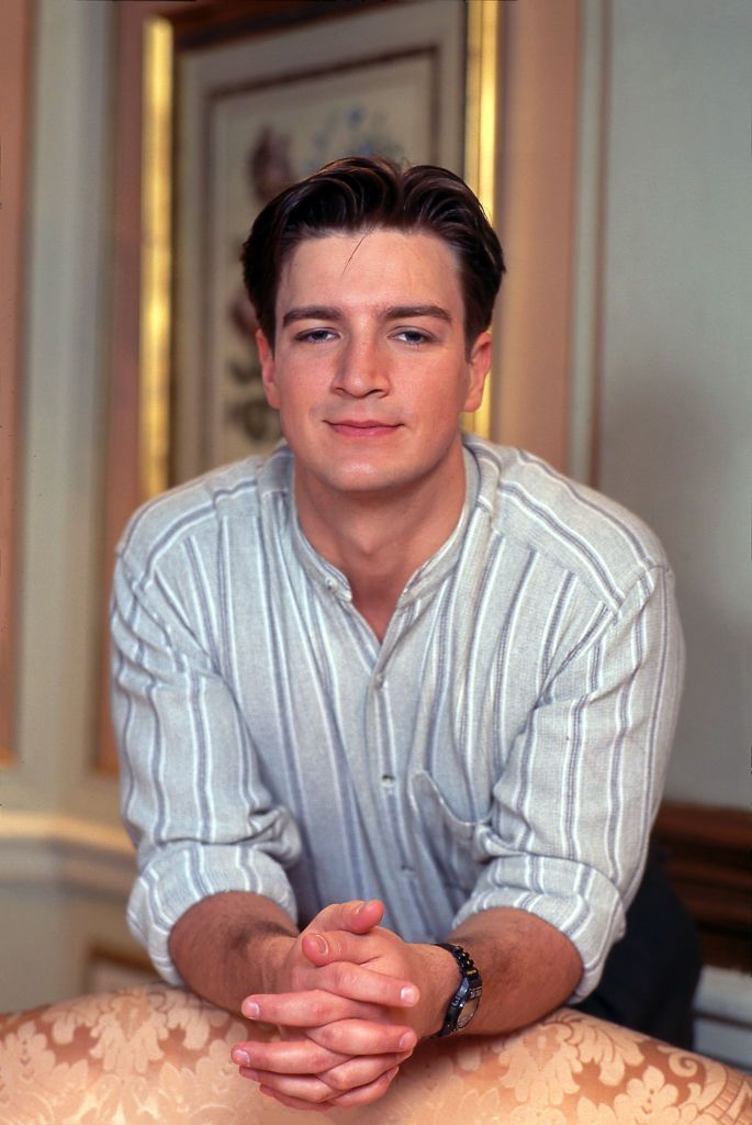 Nathan Fillion wearing a grey striped shirt in 1995. 