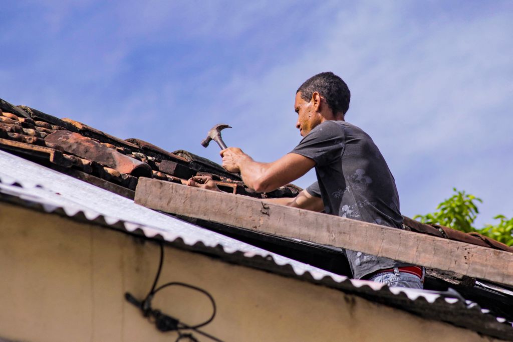 A man attempts to secure the roof of his home ahead of the arrival of Hurricane Melissa in Santiago de Cuba, Cuba
