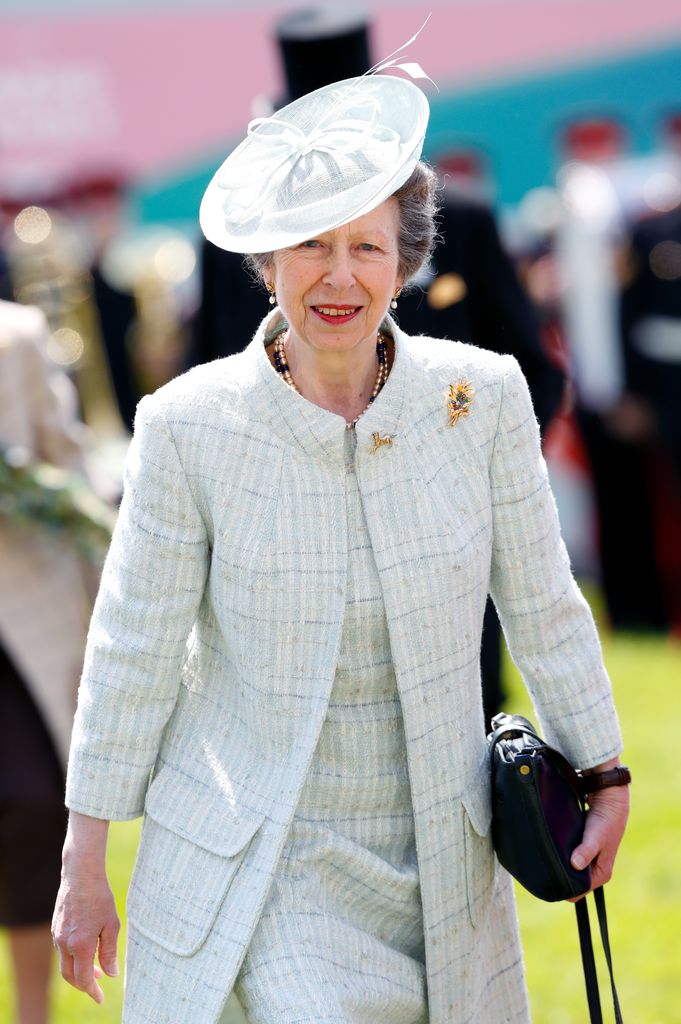 Princess Anne wearing checked coat and dress and red lipstick