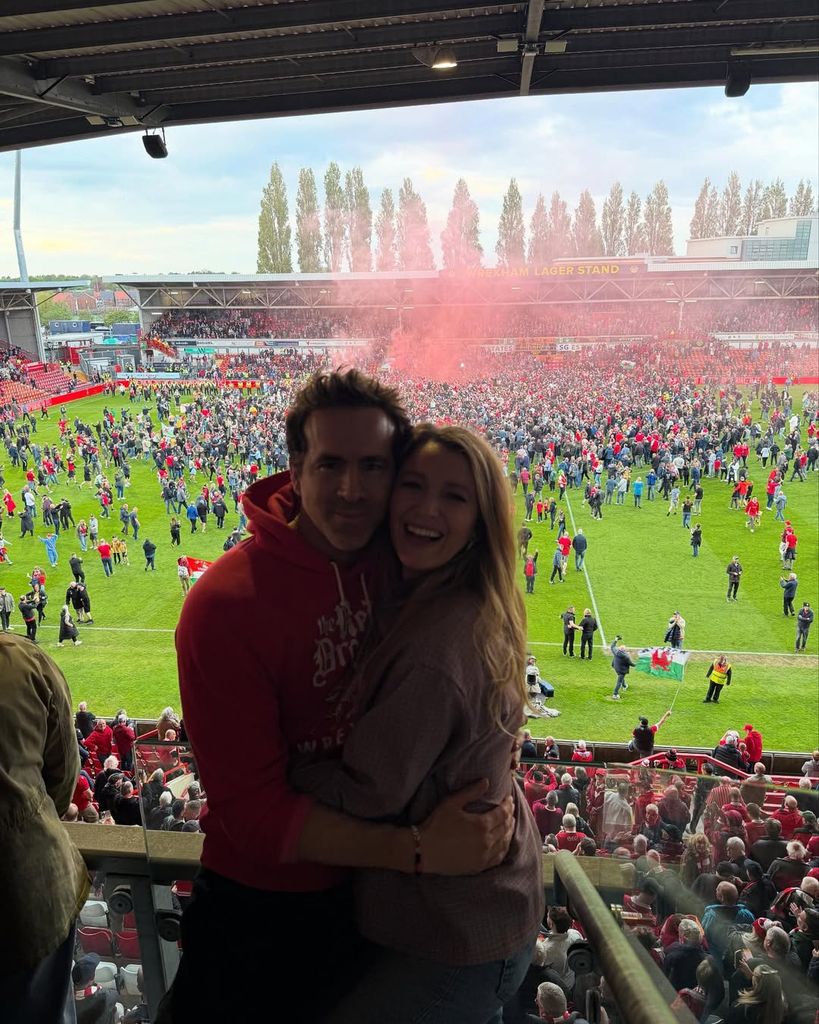 Ryan Reynolds and Blake Lively hug for a photo after Wrexham AFC's win against Charlton Athletic F.C. on Saturday, April 26