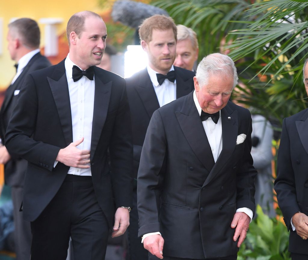 Prince William, King Charles and Prince Harry walking in black tuxedos