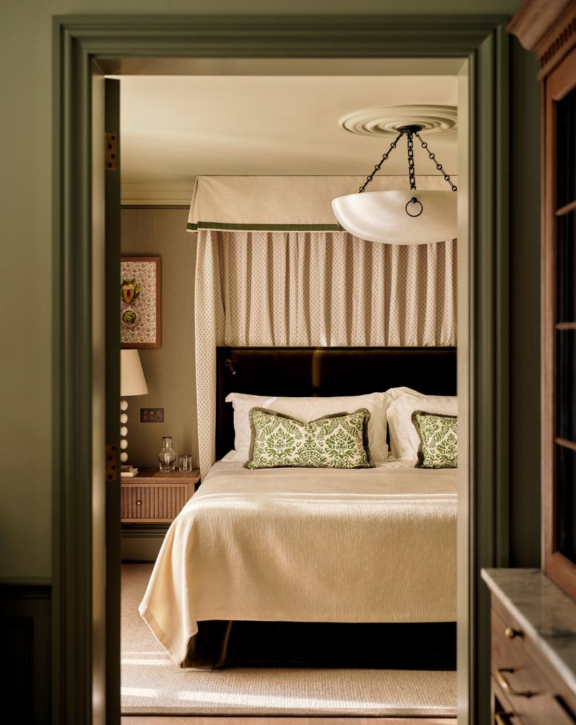 view of hotel bedroom with dark green and cream scheme
