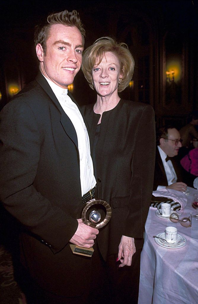 Toby Stephens holding an award with his mum Dame Maggie Smith