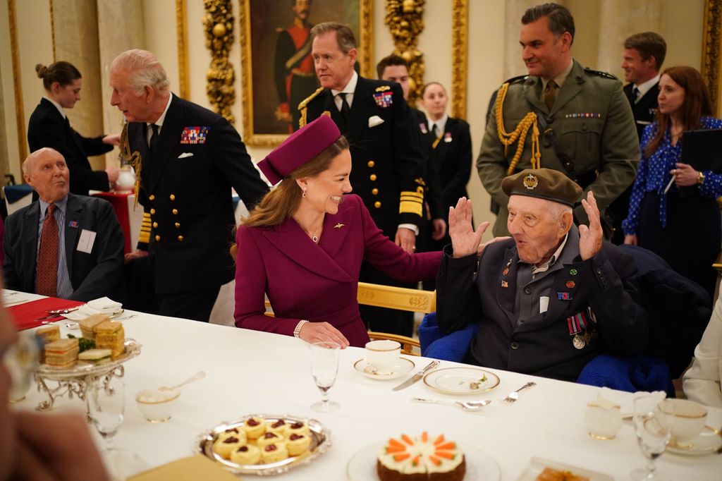 Kate Middleton giggling with veteran at palace tea party