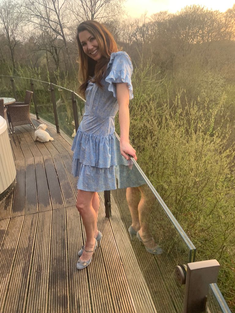 Woman in a blue dress on the balcony at Chewton Glen