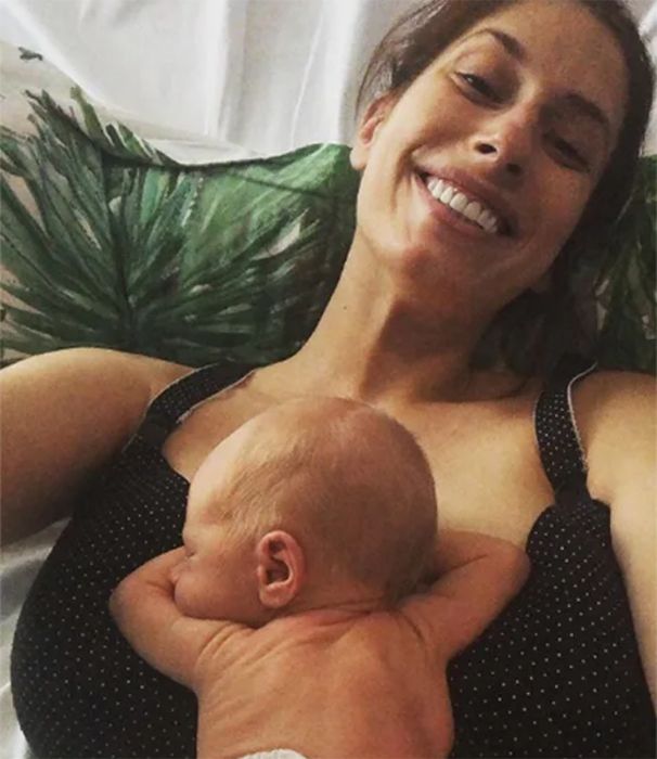 Stacey Solomon smiles with baby Rex on chest