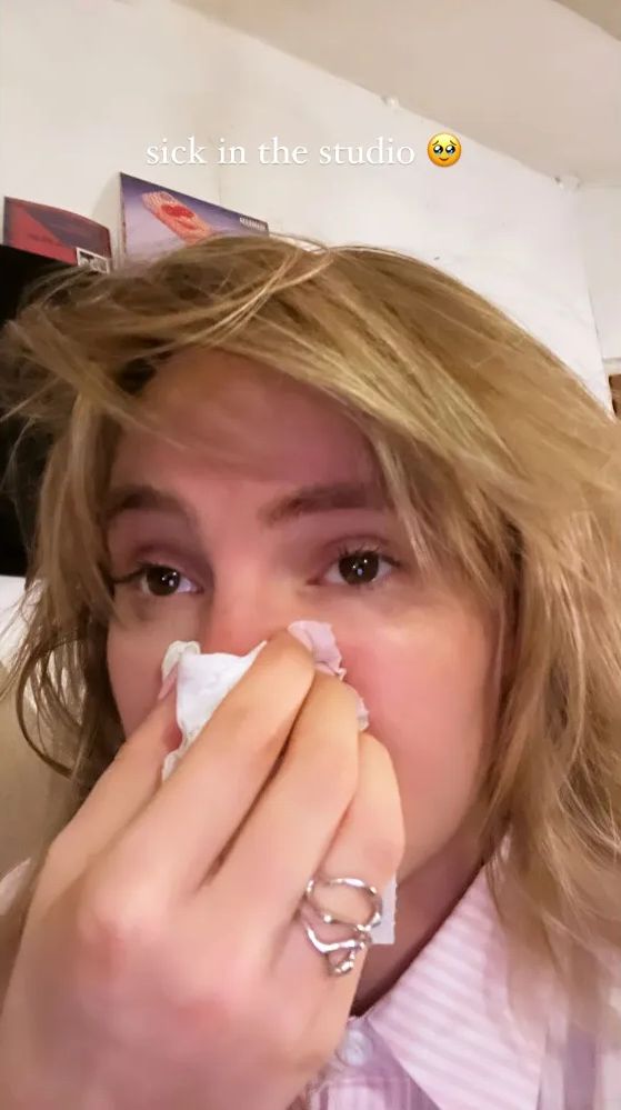 Suki Waterhouse holds a tissue to her nose as she has a cold while in the music studio