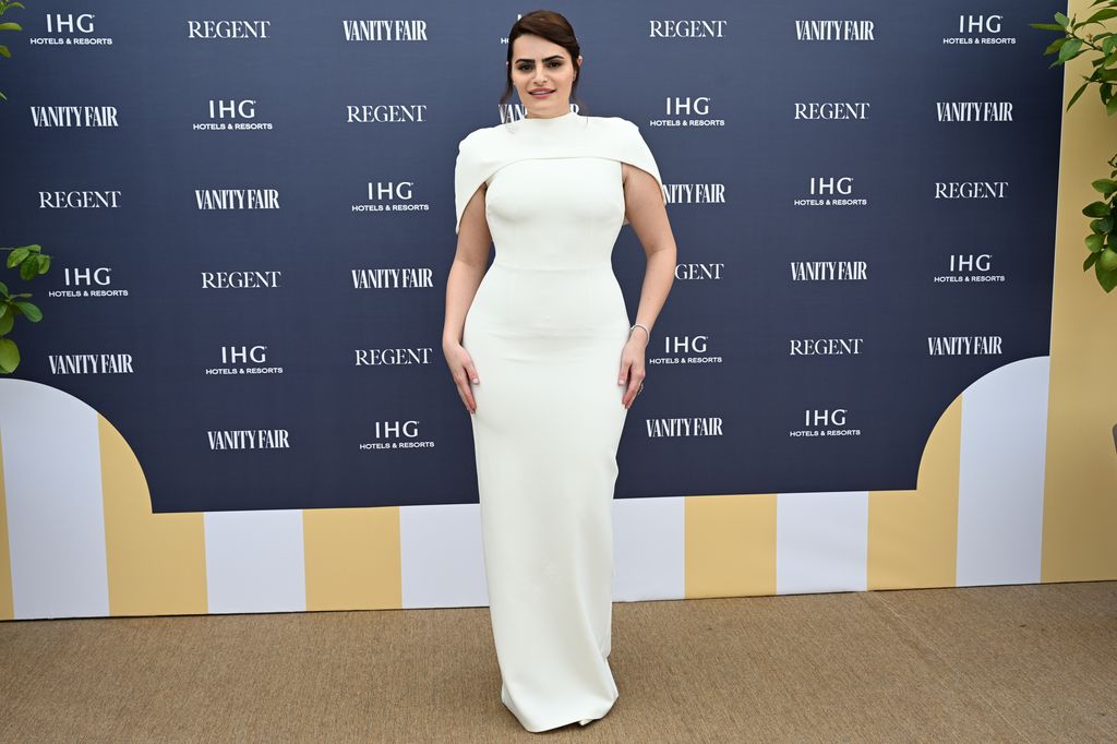 Nava Mau posed in white dress