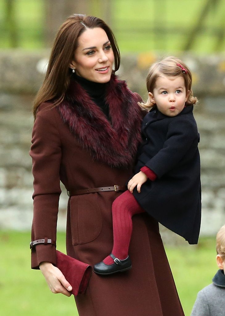 Catherine holding Princess Charlotte in coats