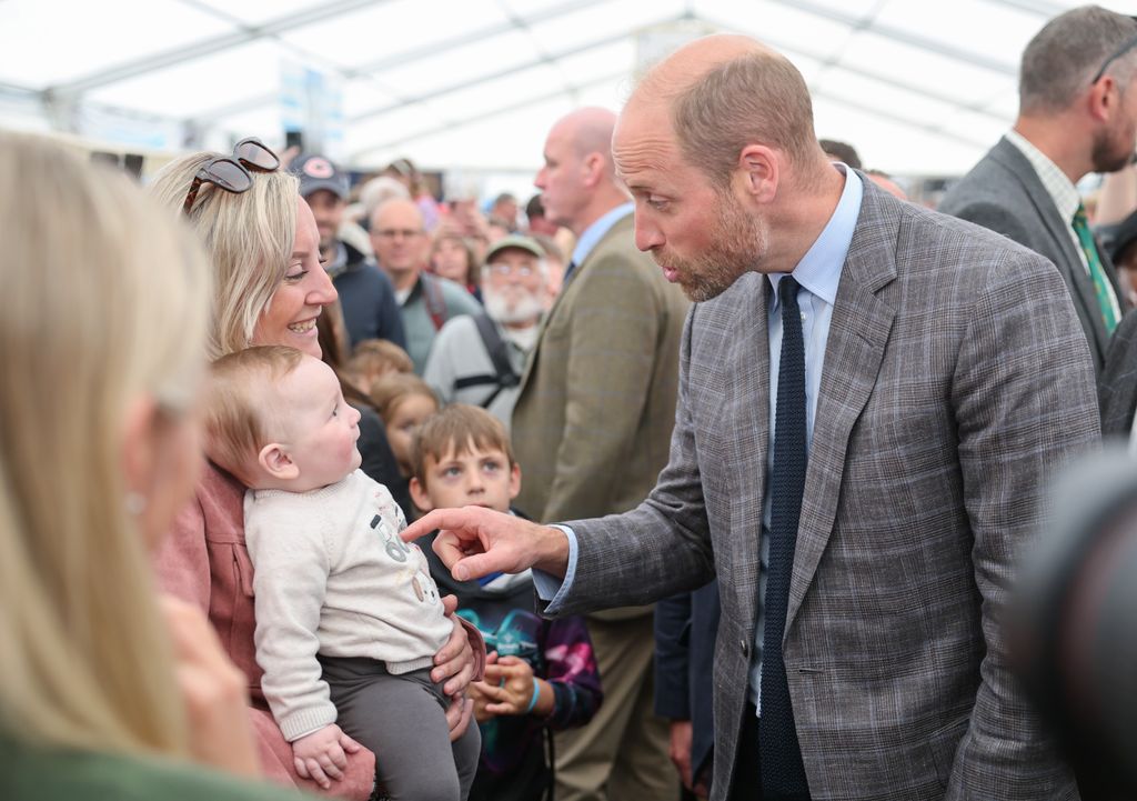 William speaking with mother and baby at Royal Cornwall Show