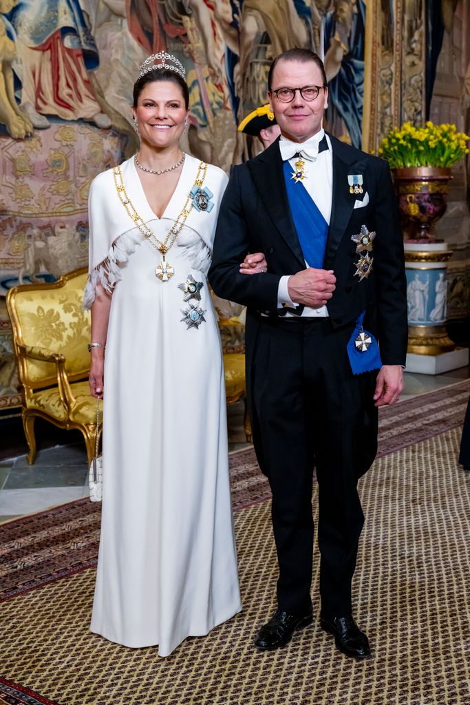 Crown Princess Victoria in feathered dress at banquet with Prince Daniel