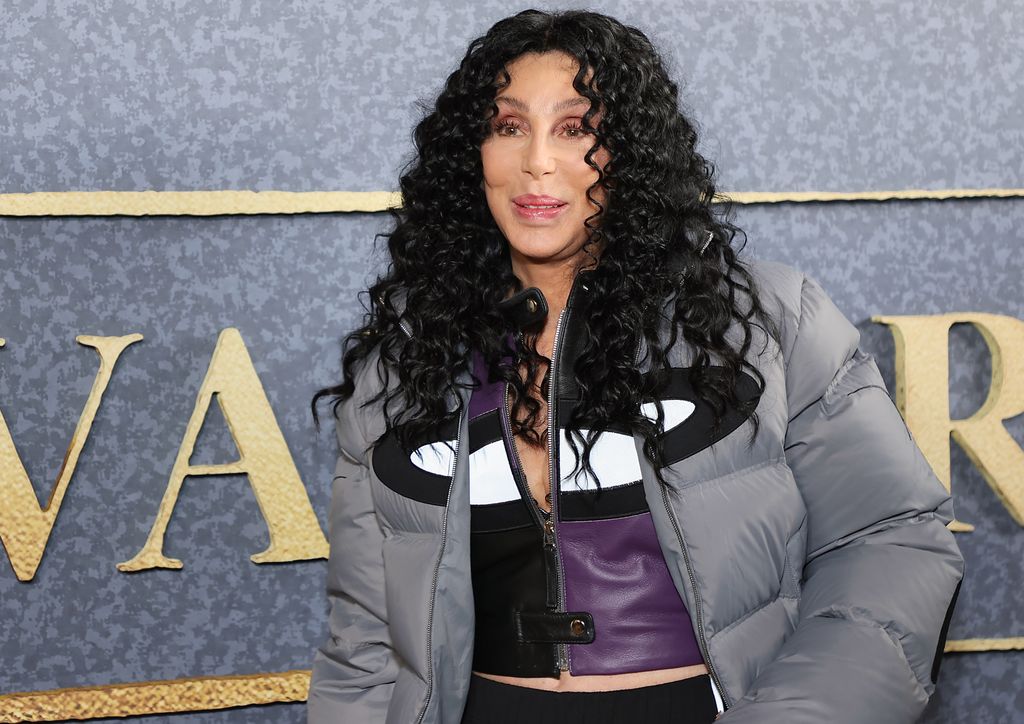 Cher looks casual in a gray puffer jacket