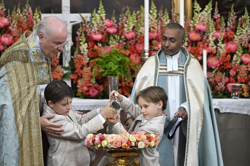 Prince Alexander and Prince Gabriel and
Prince Julian helped to pour the water into the font