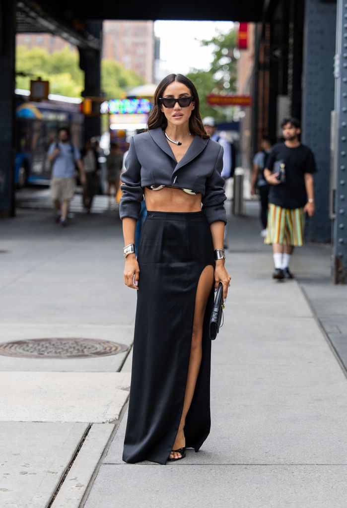 Tamara Kalinic wears cropped grey blazer, black skirt with slit, bag outside Grace Ling during New York Fashion Week on September 06, 2024 in New York City. (Photo by Christian Vierig/Getty Images)