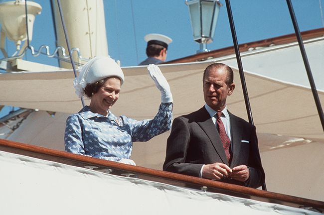 queen waving to crowds with philip hms britannia