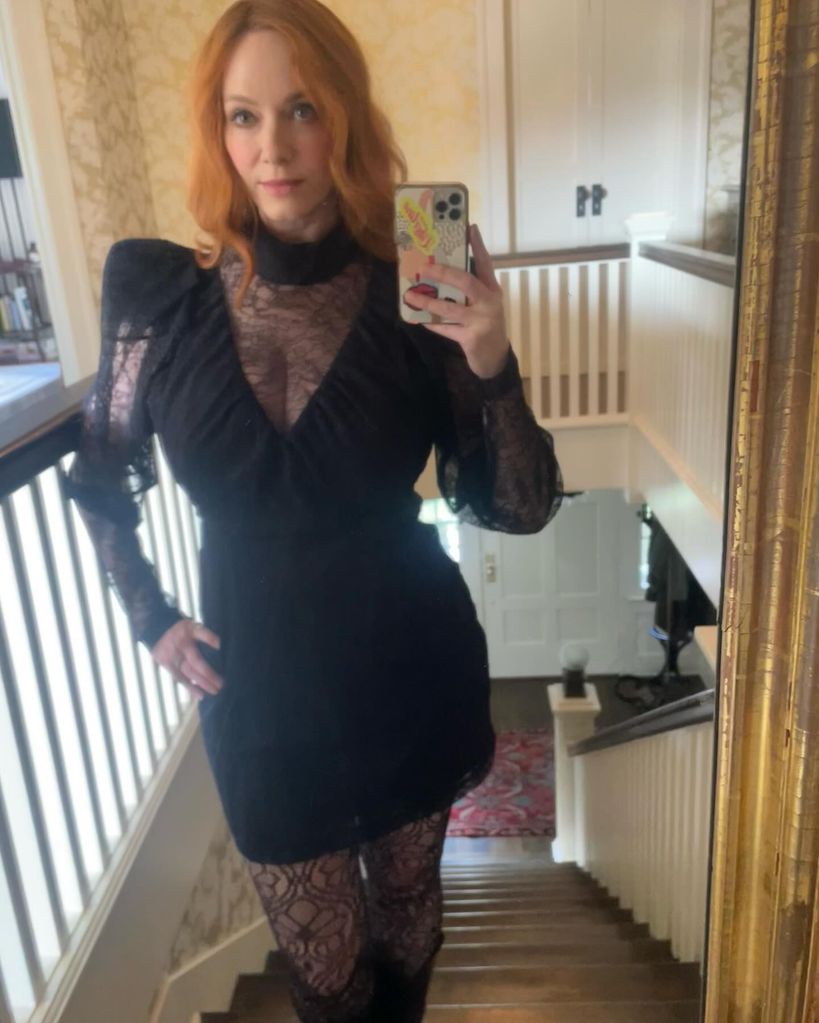 christina hendricks wearing black lace mini dress inside home