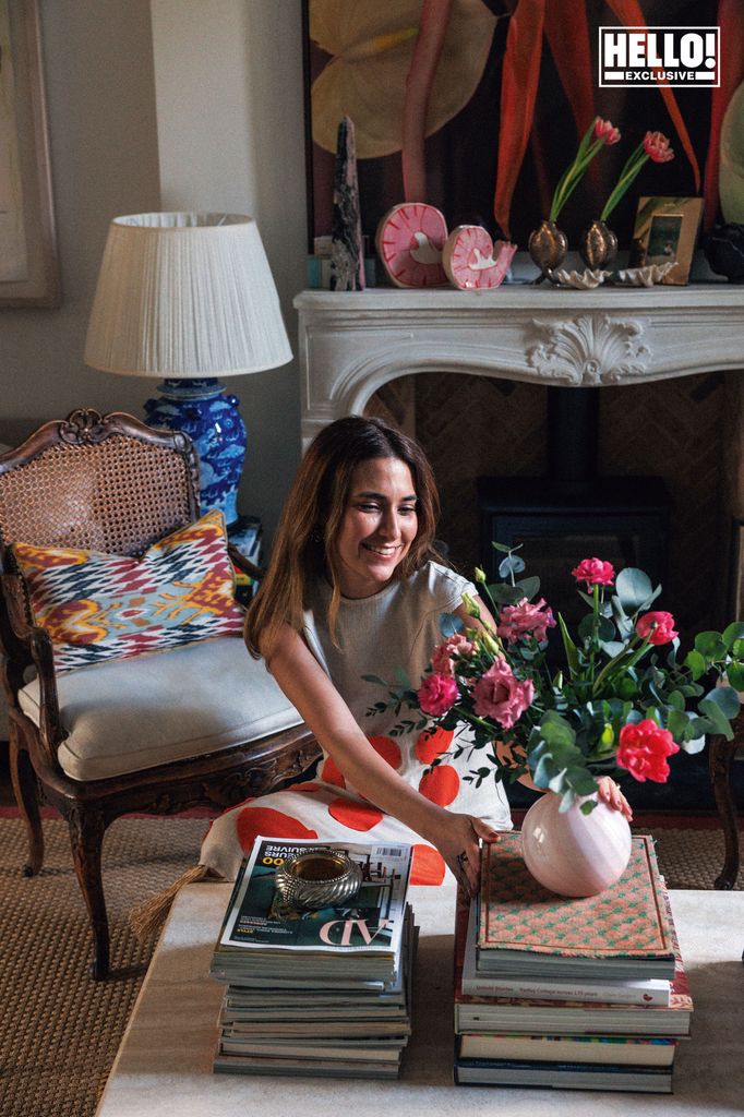 Nina Litchfield arrnaging flowers on coffee table at Notting Hill home