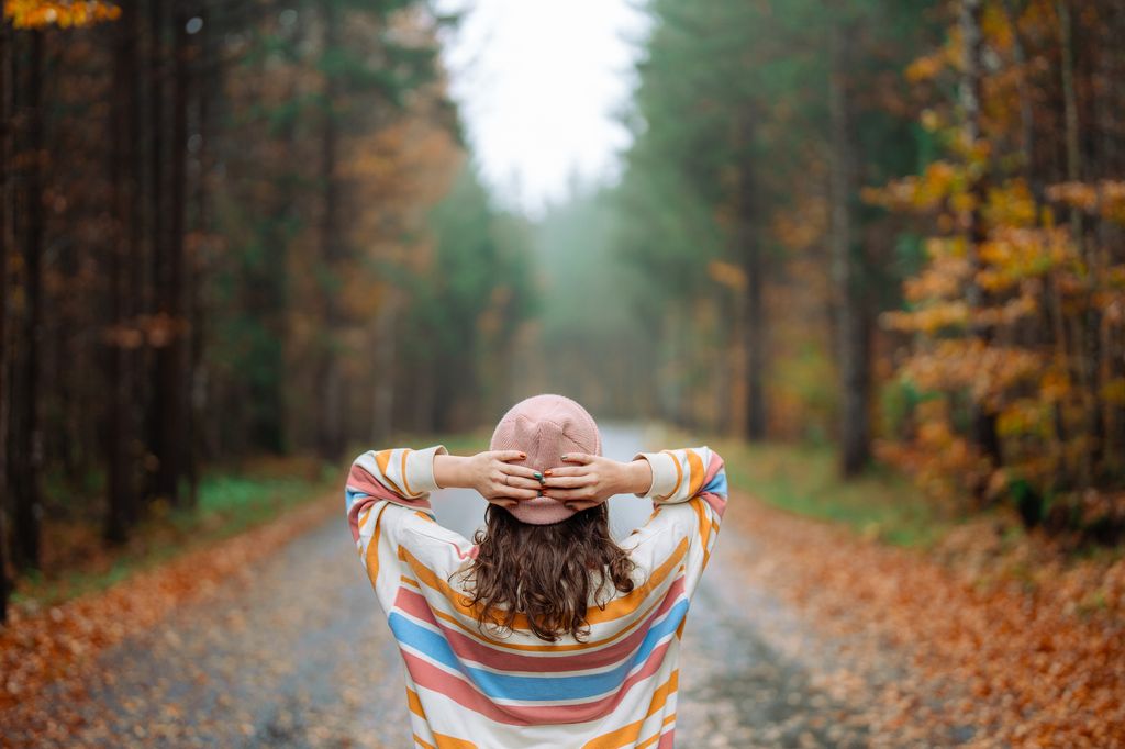 Woman walking in the autumn forest