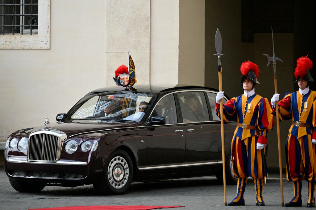 Britain's King Charles III and Britain's Queen Camilla arrive by car in San Damaso courtyard