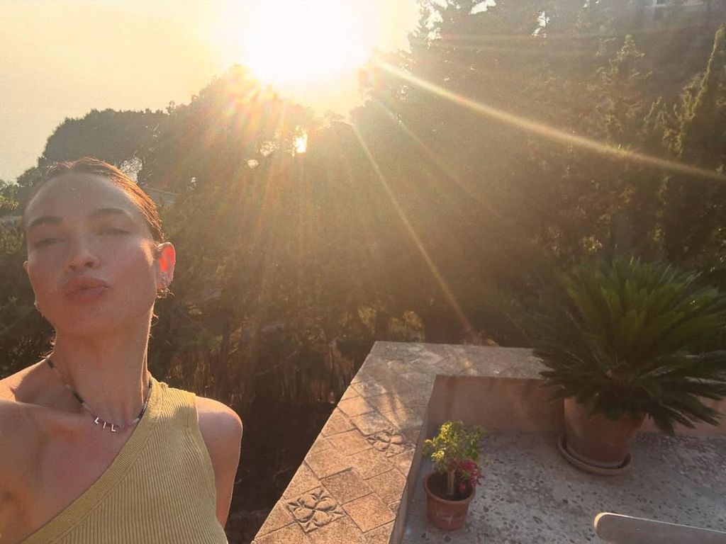 lily james selfie in green top and sunset backdrop