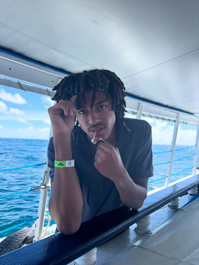 Henry on a boat at sea posing 