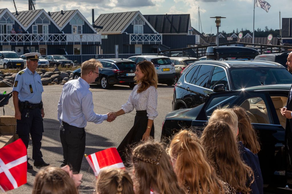 Crown Princess Mary shakes hand with guest at Grenaa sea aquarium, Kattegatcentret