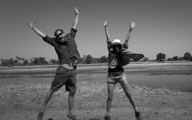 Meghan and Harry jumping in the air in black and white photo